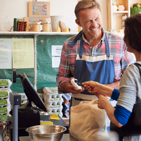 Man working with Farm Shop Epos System serving a customer.