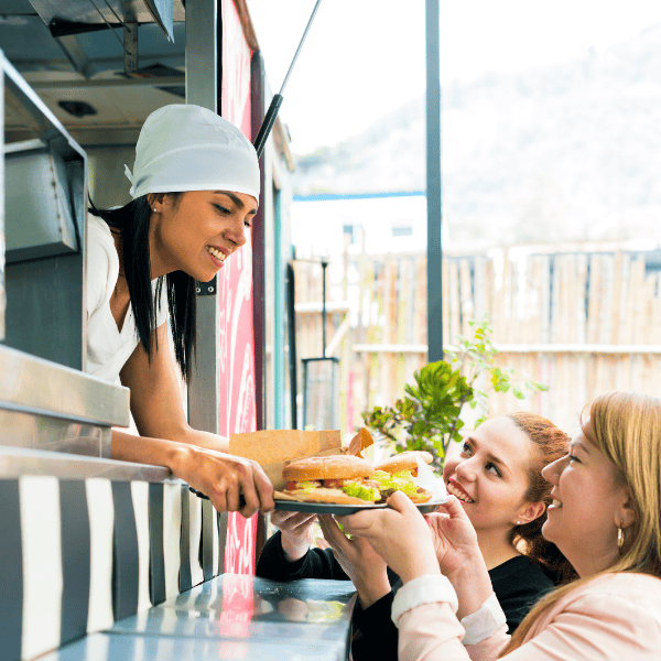 Food Truck EPOS with two female customers being served food by female staff member.