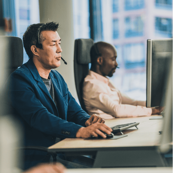 a group of remote epos support personnel working on computers in an office